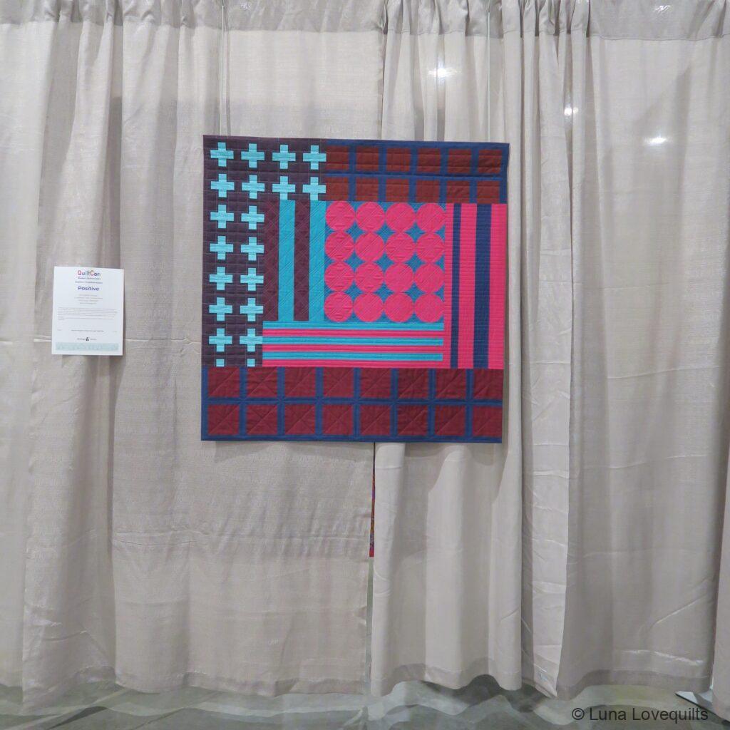 Luna Lovequilts - My Positive quilt hanging at Quiltcon 2024 in Raleigh